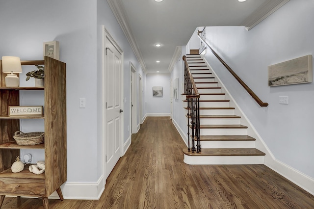 staircase with hardwood / wood-style floors and crown molding