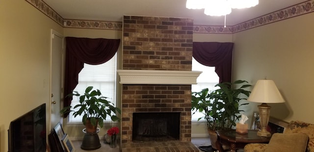 living room with a fireplace and plenty of natural light