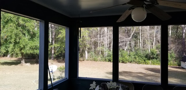 unfurnished sunroom featuring ceiling fan