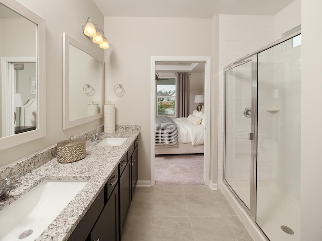 bathroom with tile patterned flooring, walk in shower, and vanity