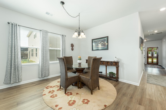 dining space with an inviting chandelier, light hardwood / wood-style floors, and a healthy amount of sunlight