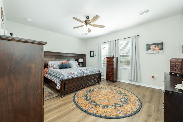 bedroom with ceiling fan and light hardwood / wood-style floors