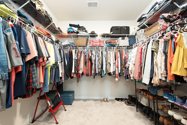 walk in closet featuring carpet flooring