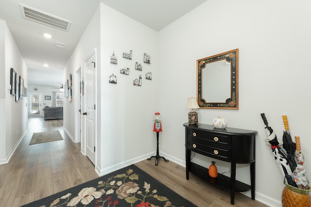 hallway with light hardwood / wood-style flooring