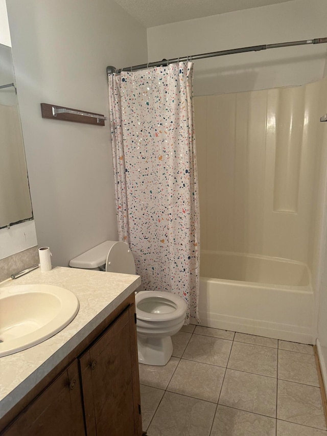 full bathroom featuring a textured ceiling, vanity, shower / bathtub combination with curtain, tile patterned flooring, and toilet