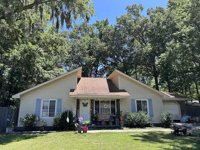 view of front of home with a porch, a garage, and a front lawn