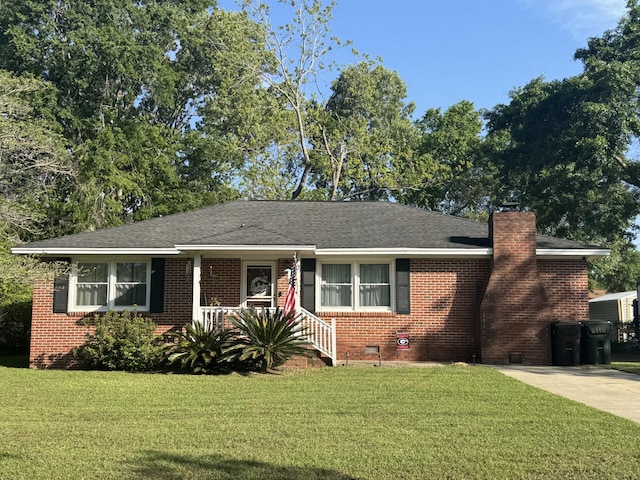 ranch-style home featuring a chimney, crawl space, a front lawn, a porch, and brick siding