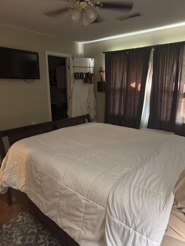 bedroom with ceiling fan and visible vents