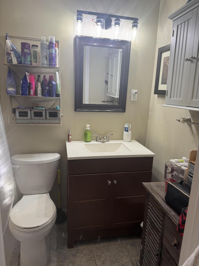 bathroom with tile patterned floors, vanity, and toilet