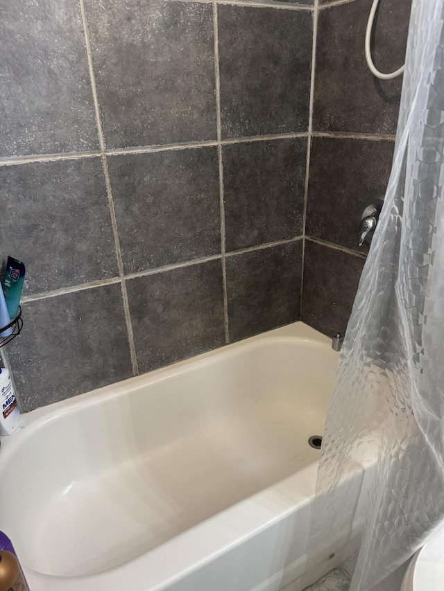 full bathroom featuring a shower with curtain and a tub to relax in