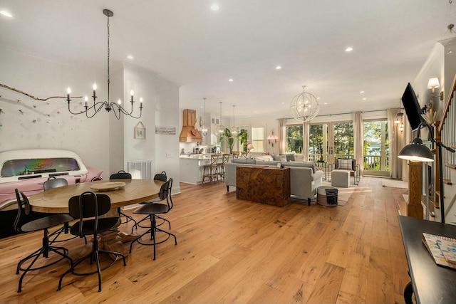 dining space with a notable chandelier and light wood-type flooring