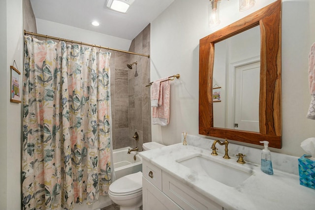 full bathroom featuring shower / bath combination with curtain, vanity, and toilet