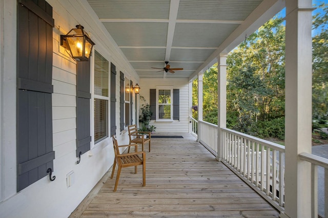 wooden terrace featuring ceiling fan and a porch