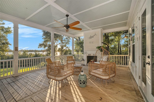 exterior space with coffered ceiling and ceiling fan