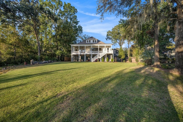 back of property featuring a yard and a sunroom