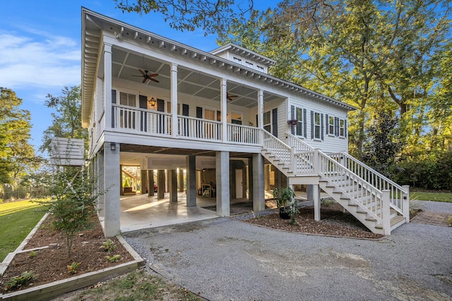 view of front facade with ceiling fan, a porch, and a carport