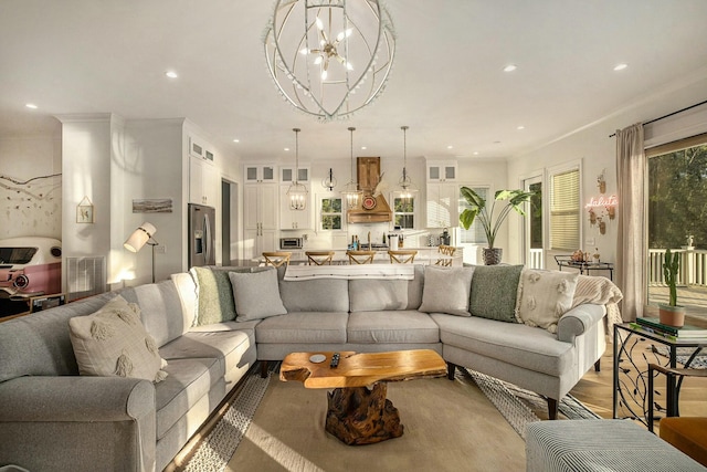 living room with wood-type flooring and a chandelier