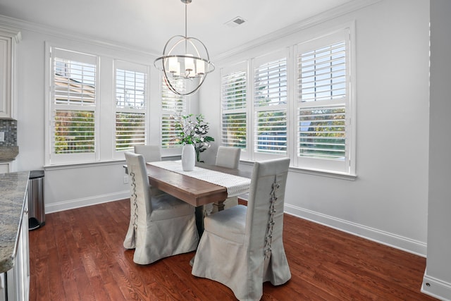 dining area with dark wood-type flooring, plenty of natural light, ornamental molding, and a notable chandelier