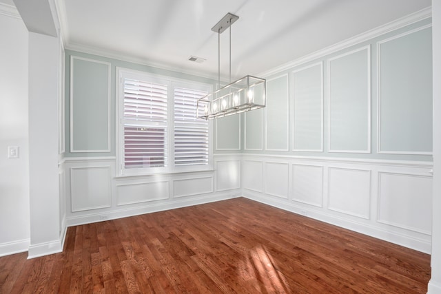 unfurnished dining area with ornamental molding, a chandelier, and dark hardwood / wood-style floors