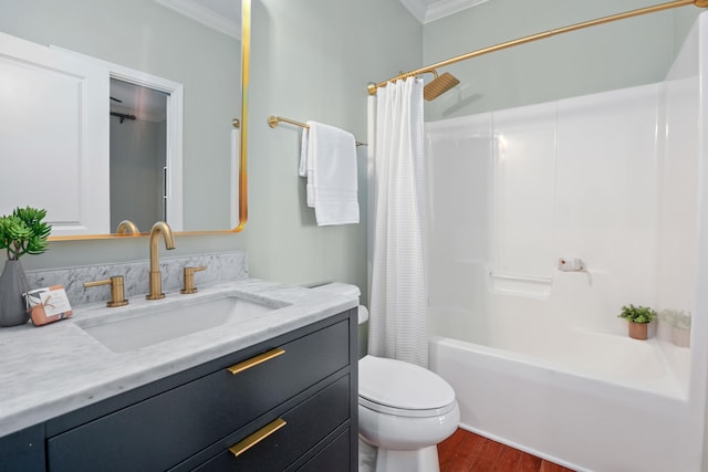 full bathroom featuring hardwood / wood-style floors, vanity, crown molding, shower / bath combo, and toilet