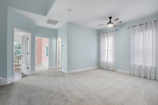 carpeted spare room with ceiling fan