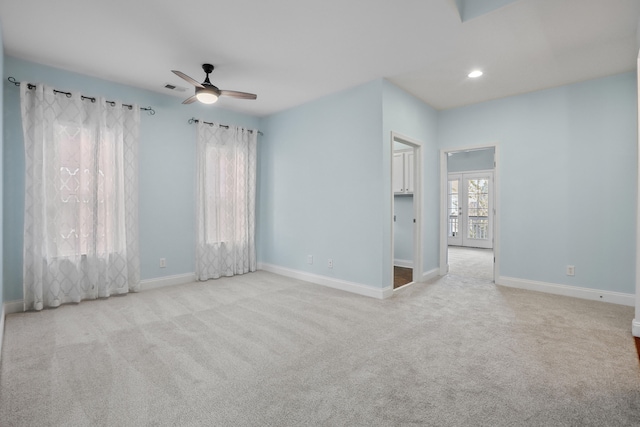 carpeted spare room with ceiling fan