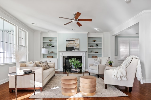 living room with ornamental molding, ceiling fan, wood-type flooring, and built in features