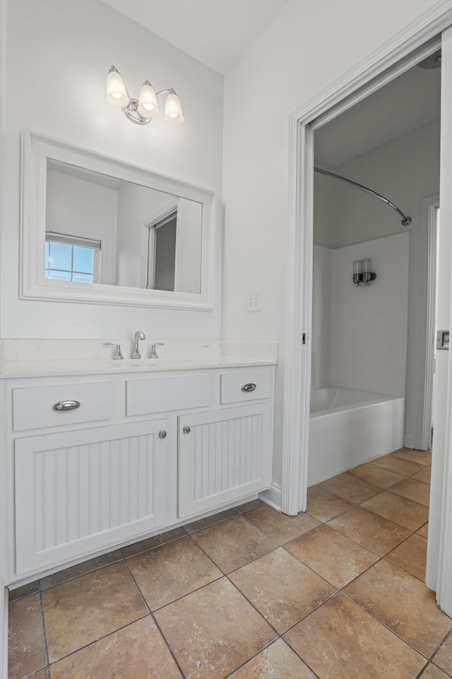 bathroom featuring washtub / shower combination and vanity