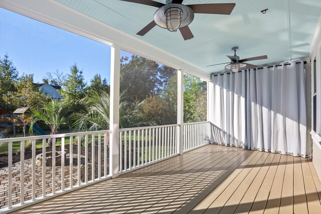 unfurnished sunroom with plenty of natural light and ceiling fan