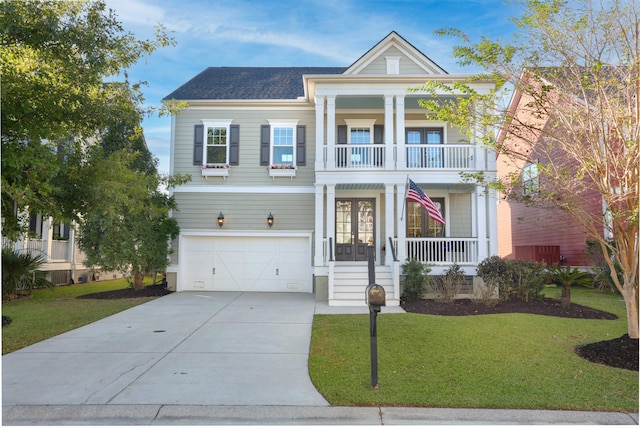 greek revival house featuring a porch, a balcony, a front yard, and a garage