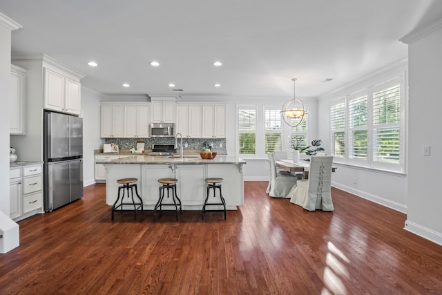 kitchen featuring appliances with stainless steel finishes, white cabinetry, and dark hardwood / wood-style flooring