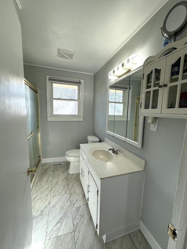 bathroom featuring walk in shower, ornamental molding, vanity, and toilet