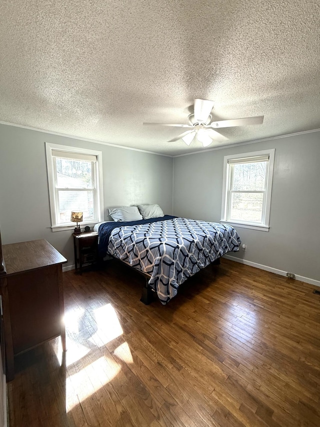 bedroom featuring ceiling fan, dark hardwood / wood-style flooring, and a textured ceiling