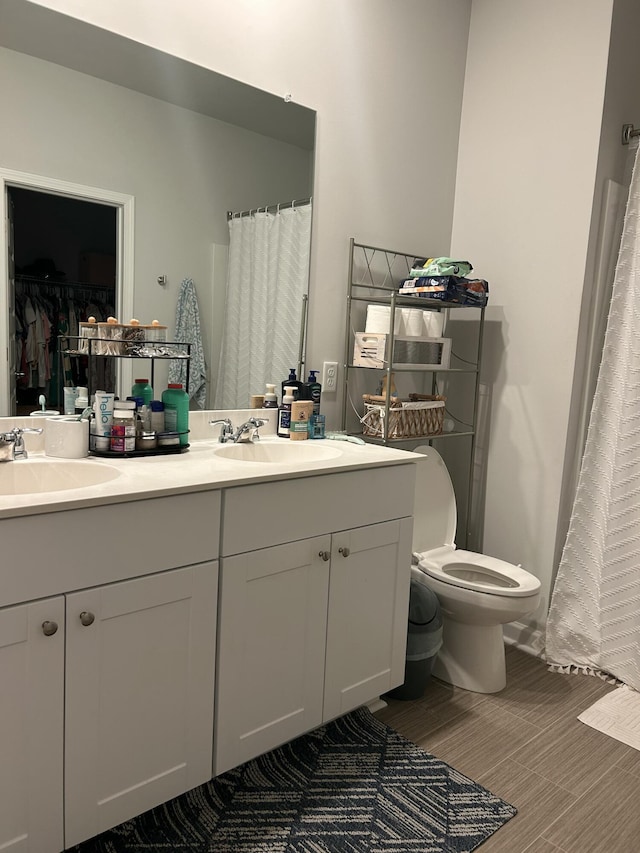 305 Camellia Bloom Dr, Moncks Corner, SC 29461 - bathroom featuring double vanity, toilet, wood finished floors, and a spacious closet
