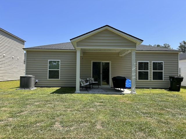 305 Camellia Bloom Dr, Moncks Corner, SC 29461 - back of house with central AC unit, roof with shingles, a patio area, and a lawn