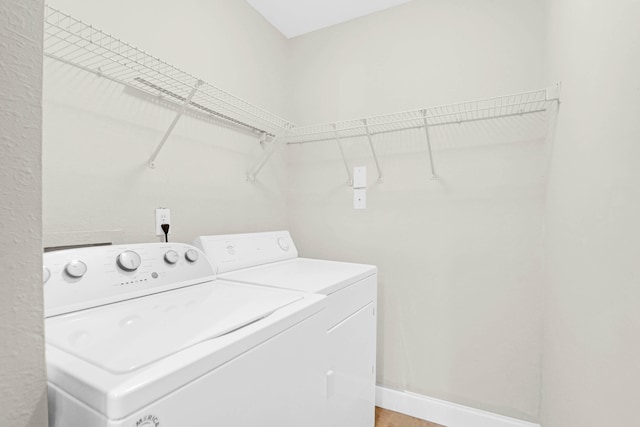 laundry room featuring washing machine and clothes dryer