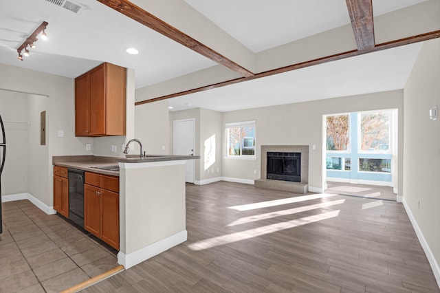 kitchen featuring light hardwood / wood-style floors, kitchen peninsula, and dishwasher