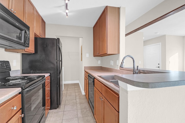 kitchen with light tile patterned flooring, kitchen peninsula, black appliances, and sink