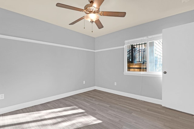 empty room with hardwood / wood-style flooring and ceiling fan