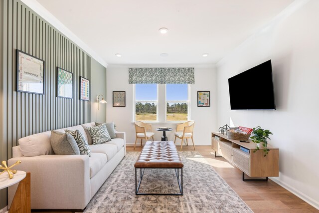 living room featuring ornamental molding and light hardwood / wood-style floors