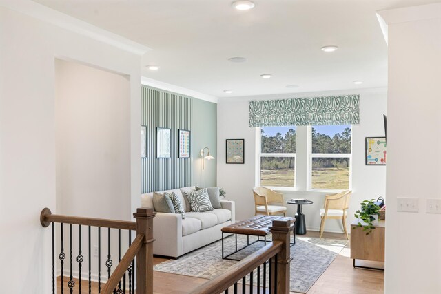 living room with crown molding and light hardwood / wood-style flooring