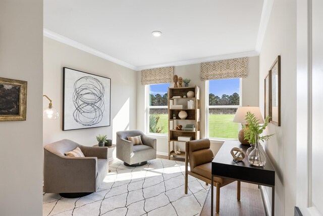 sitting room featuring ornamental molding and light wood-type flooring