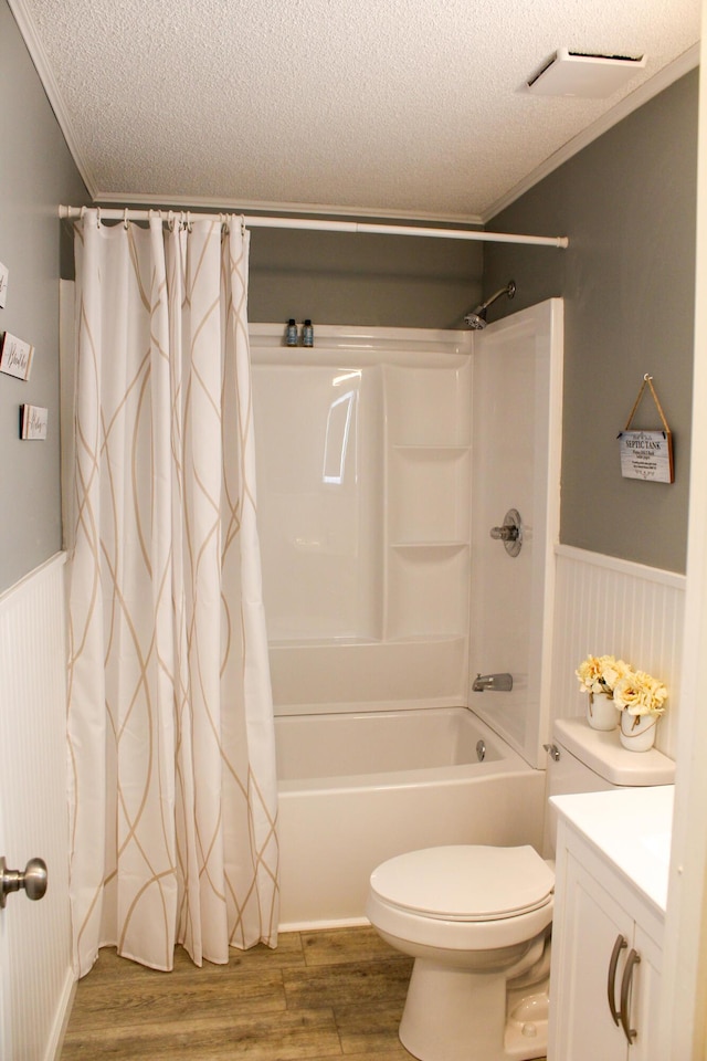 full bathroom with hardwood / wood-style floors, vanity, ornamental molding, and a textured ceiling