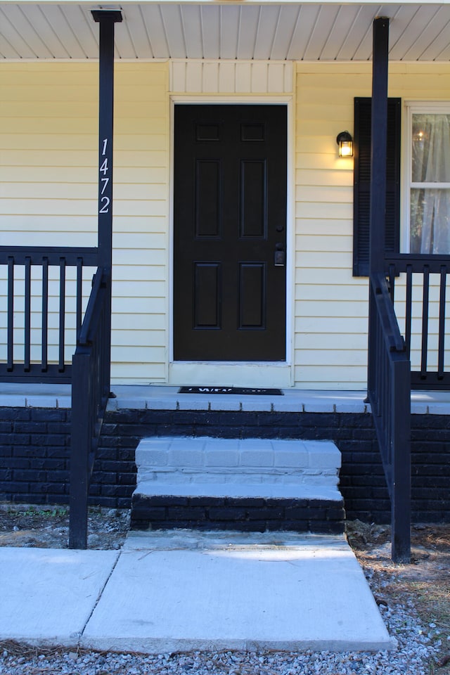 doorway to property featuring a porch