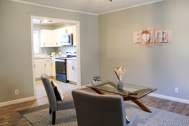 dining area featuring light wood-type flooring and ornamental molding