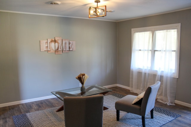 living area with a chandelier, dark wood-type flooring, and crown molding