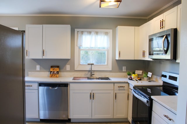 kitchen featuring crown molding, sink, white cabinets, and appliances with stainless steel finishes