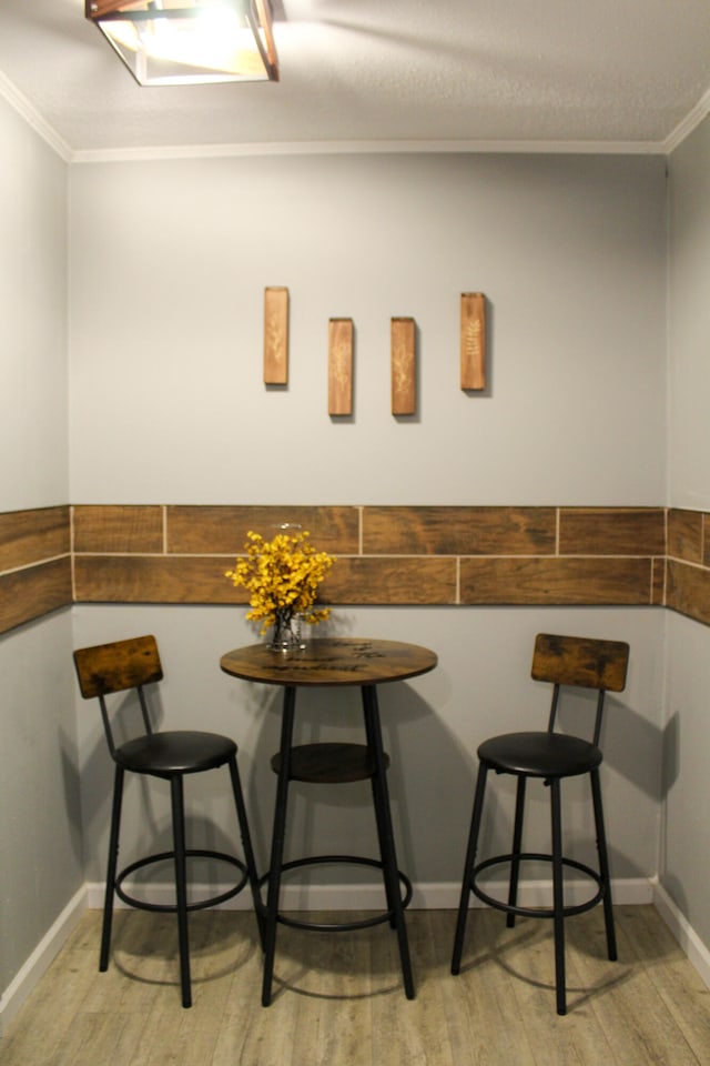 interior space with light hardwood / wood-style floors and crown molding