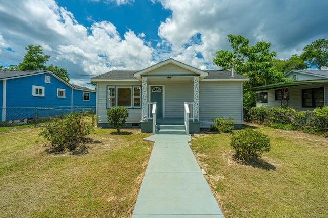 bungalow with crawl space, a porch, a front lawn, and fence