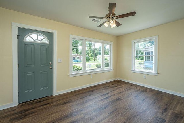 entrance foyer with dark wood finished floors, visible vents, a ceiling fan, and baseboards